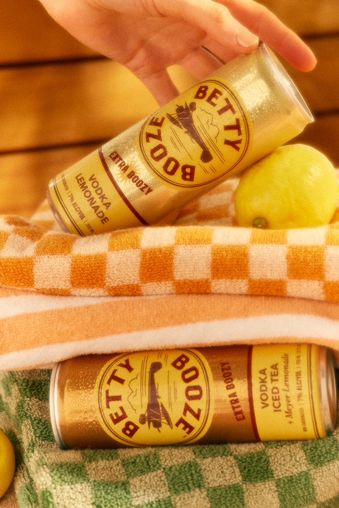 Betty Booze Extra Boozy Cans in a towel
