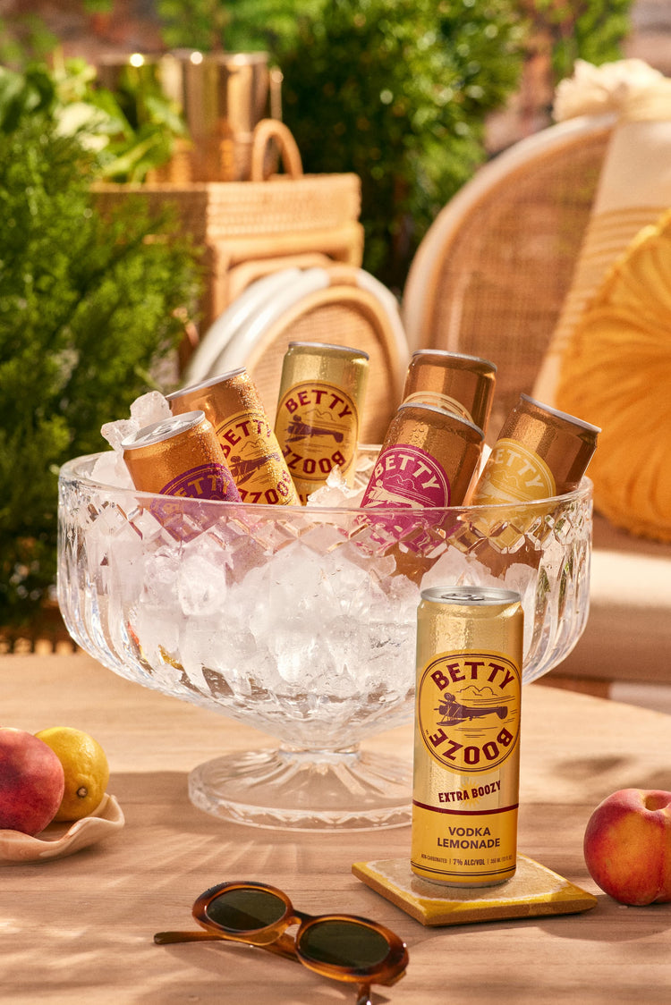 Betty Booze Extra Boozy Vodka Lemonade on a table next to ice bucket