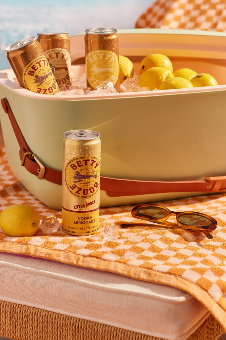 Betty Booze Extra Boozy Vodka Lemonade on a table next to ice bucket